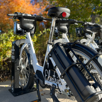 An electric bike parked with fall leaves in the background. 