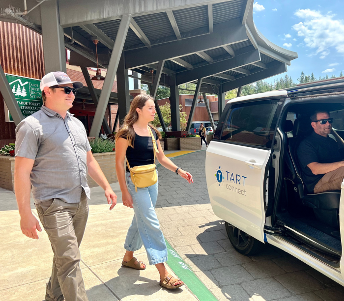 Man and women leaving hospital to get in a shared shuttle bus. 