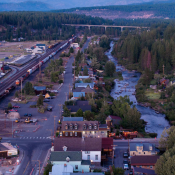 Birds-eye view of Truckee River and Downtown Truckee with railroad and overpass featured. 