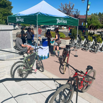 People around the Town of Truckee pop-up tent with their bikes for Bike Everywhere Day