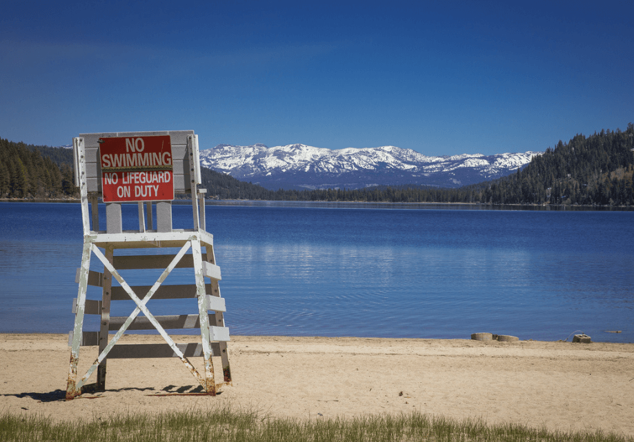 Lifeguard chair facing empty West End Beach at Donner Lake. 