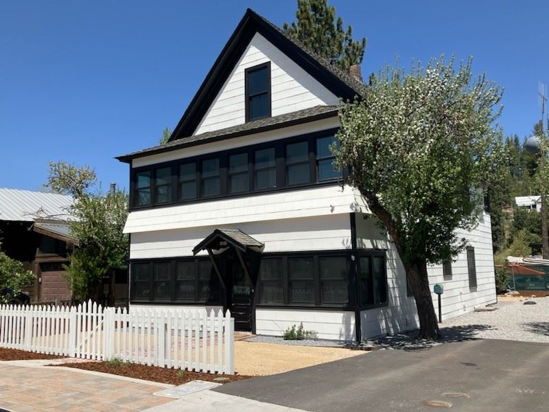 black and white house with white picket fence