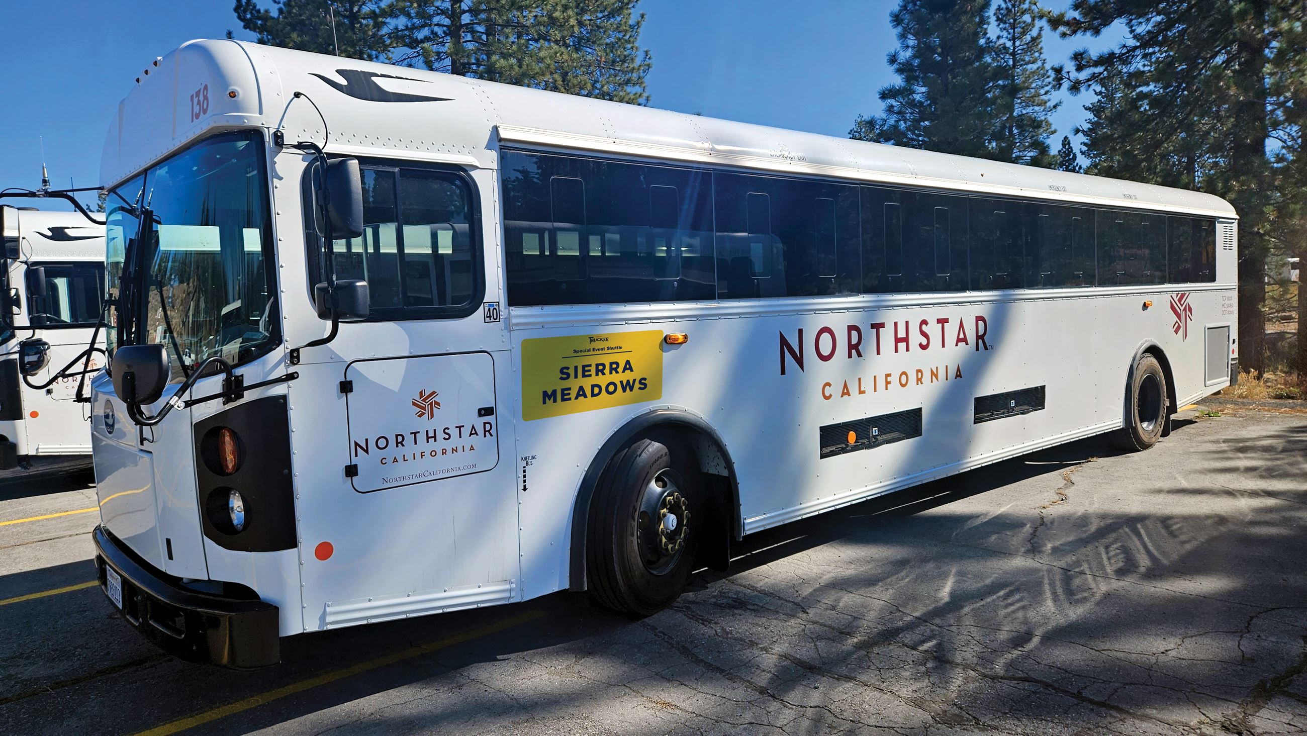 white bus with yellow magnet displaying route name
