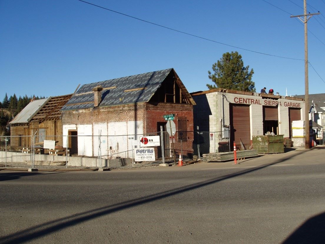 Old Chinese Herb Shop rundown with fence around it. 